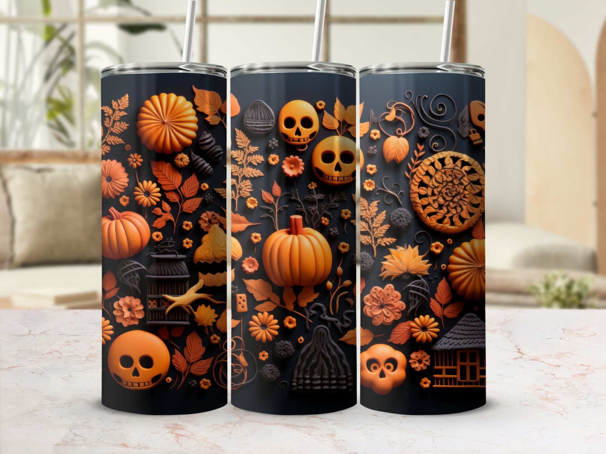 Three tumblers with Halloween-themed orange and black raised designs, including pumpkins and skulls.