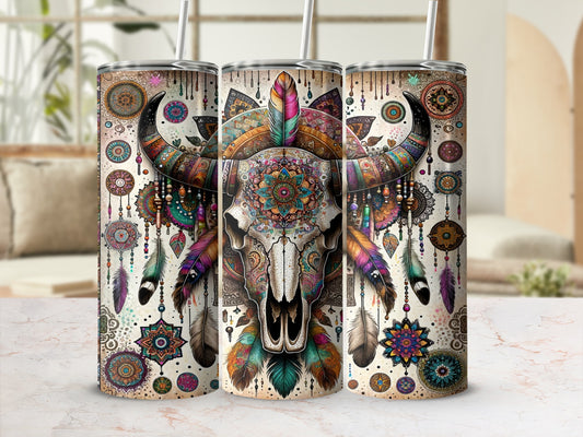 Bull skull with colorful mandala and feather adornments on a tumbler.