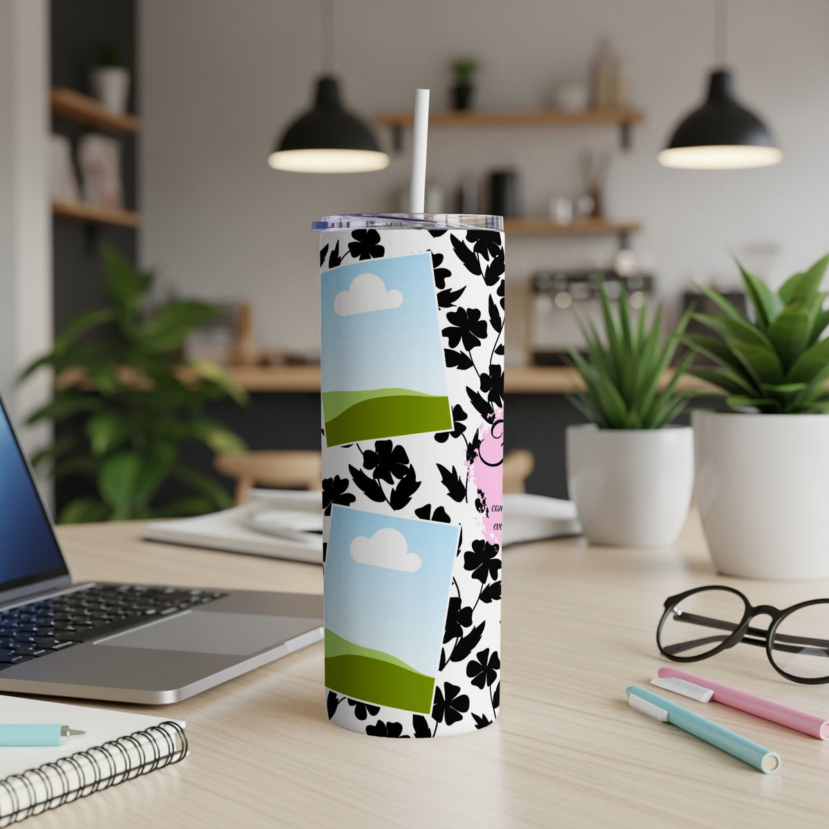 Tumbler with black floral pattern, two photo frames, and a pink accent.