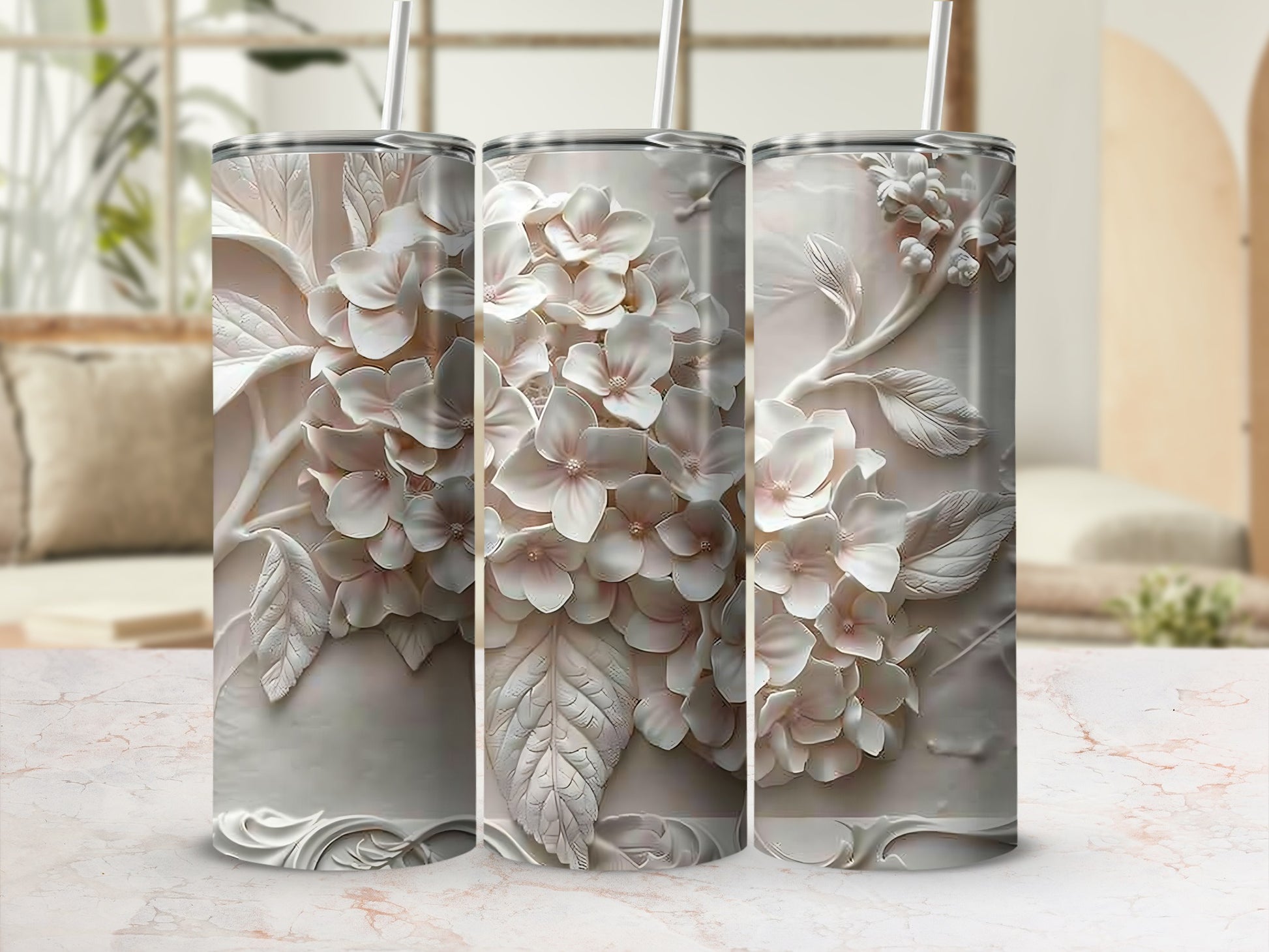 3D embossed hydrangea pattern on white skinny tumblers with straws.