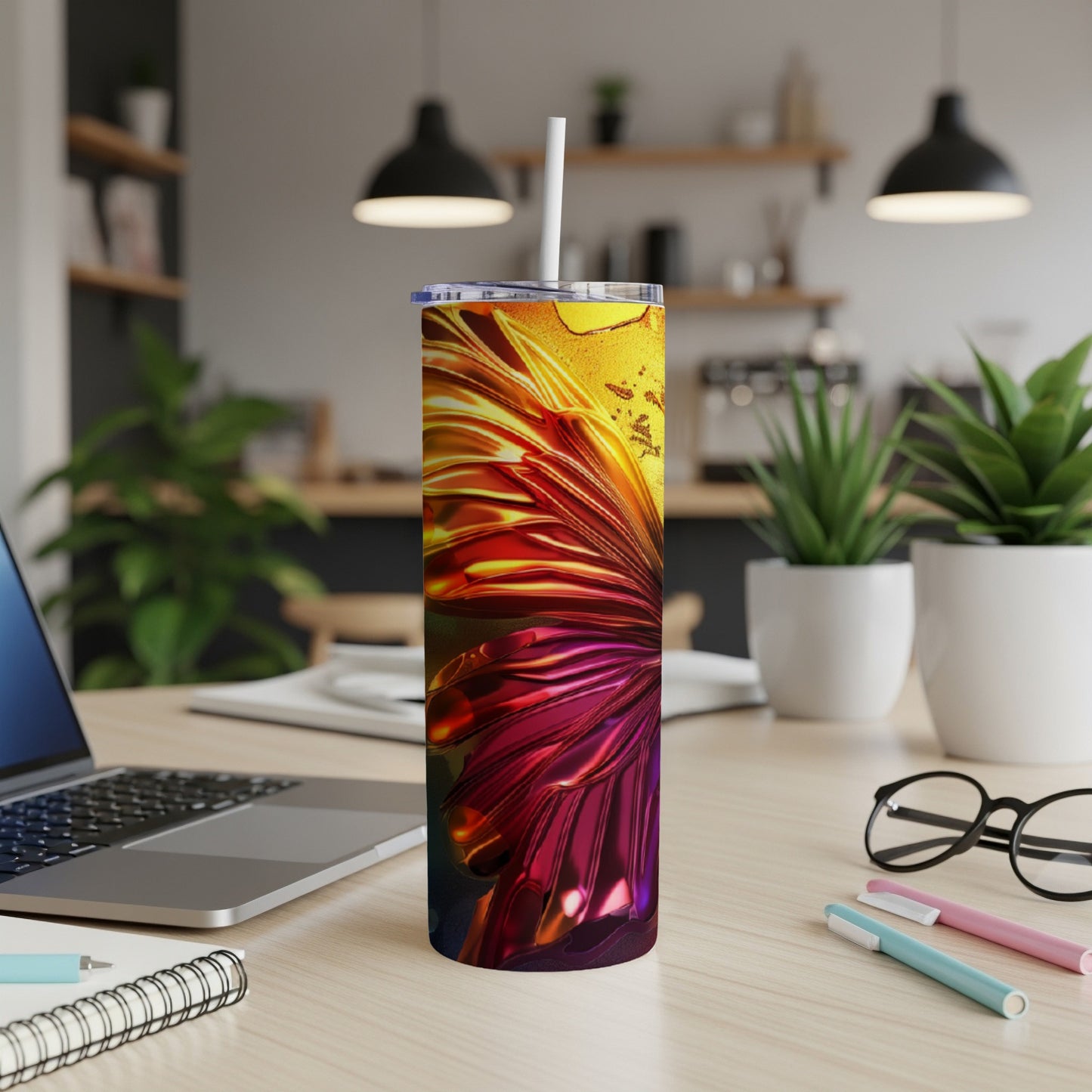 Tall tumbler with fiery orange and red abstract floral design, white straw.
