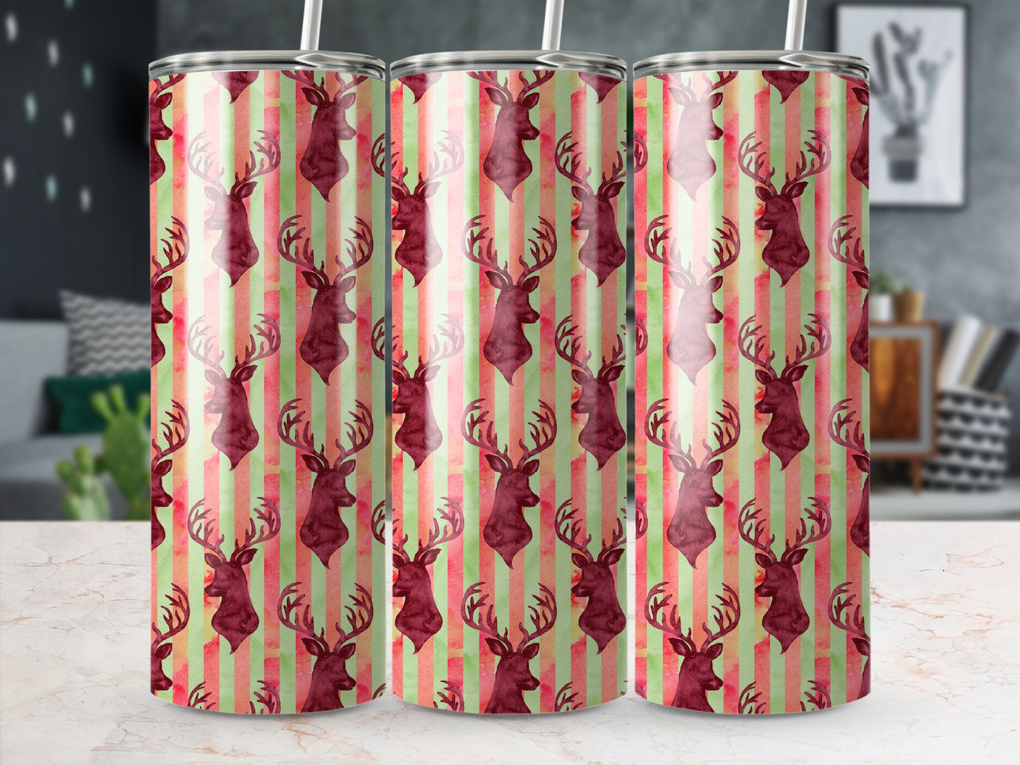 Three tumblers with a repeating pattern of burgundy deer on a striped background.