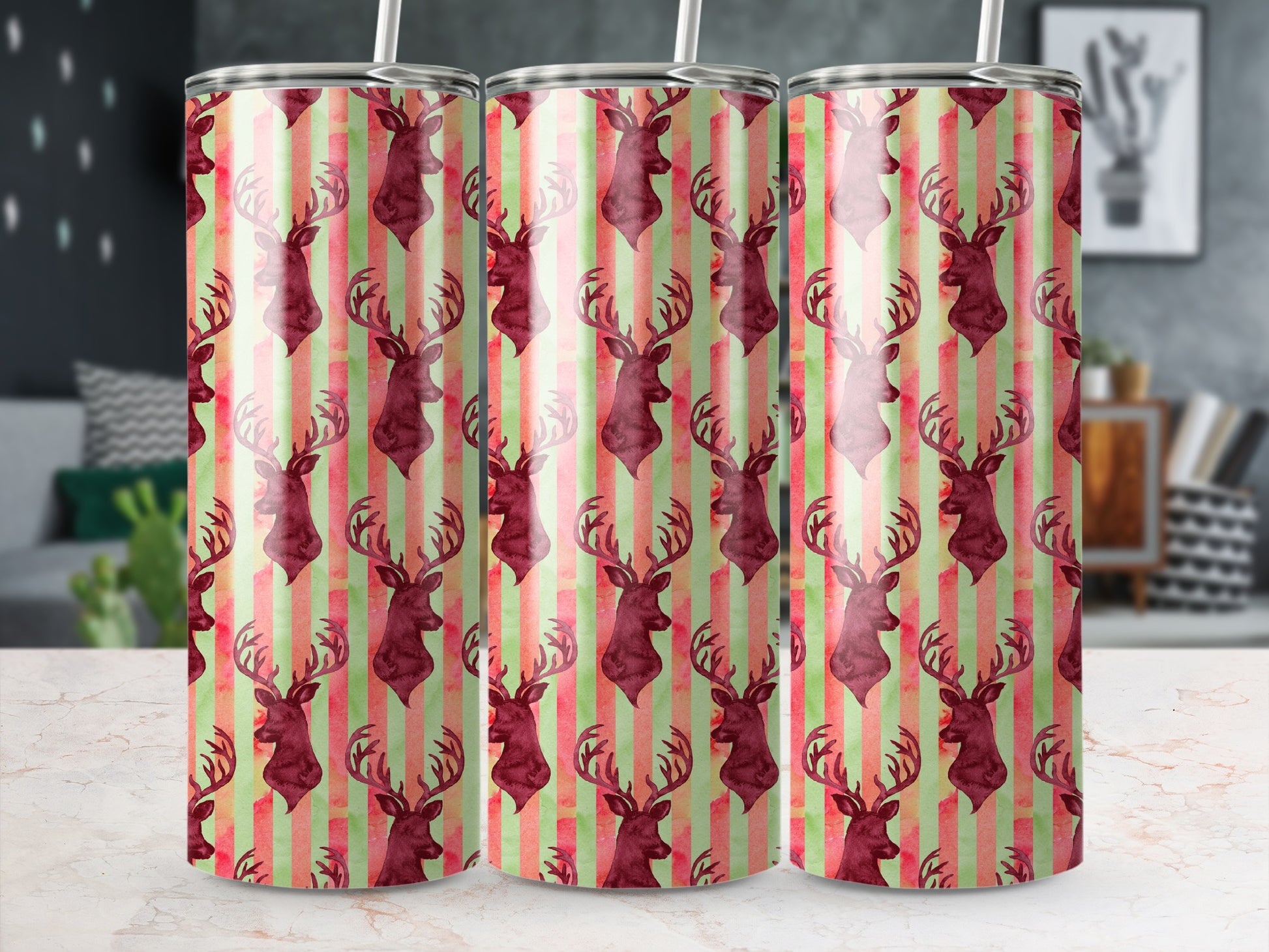 Three tumblers with a repeating pattern of burgundy deer on a striped background.