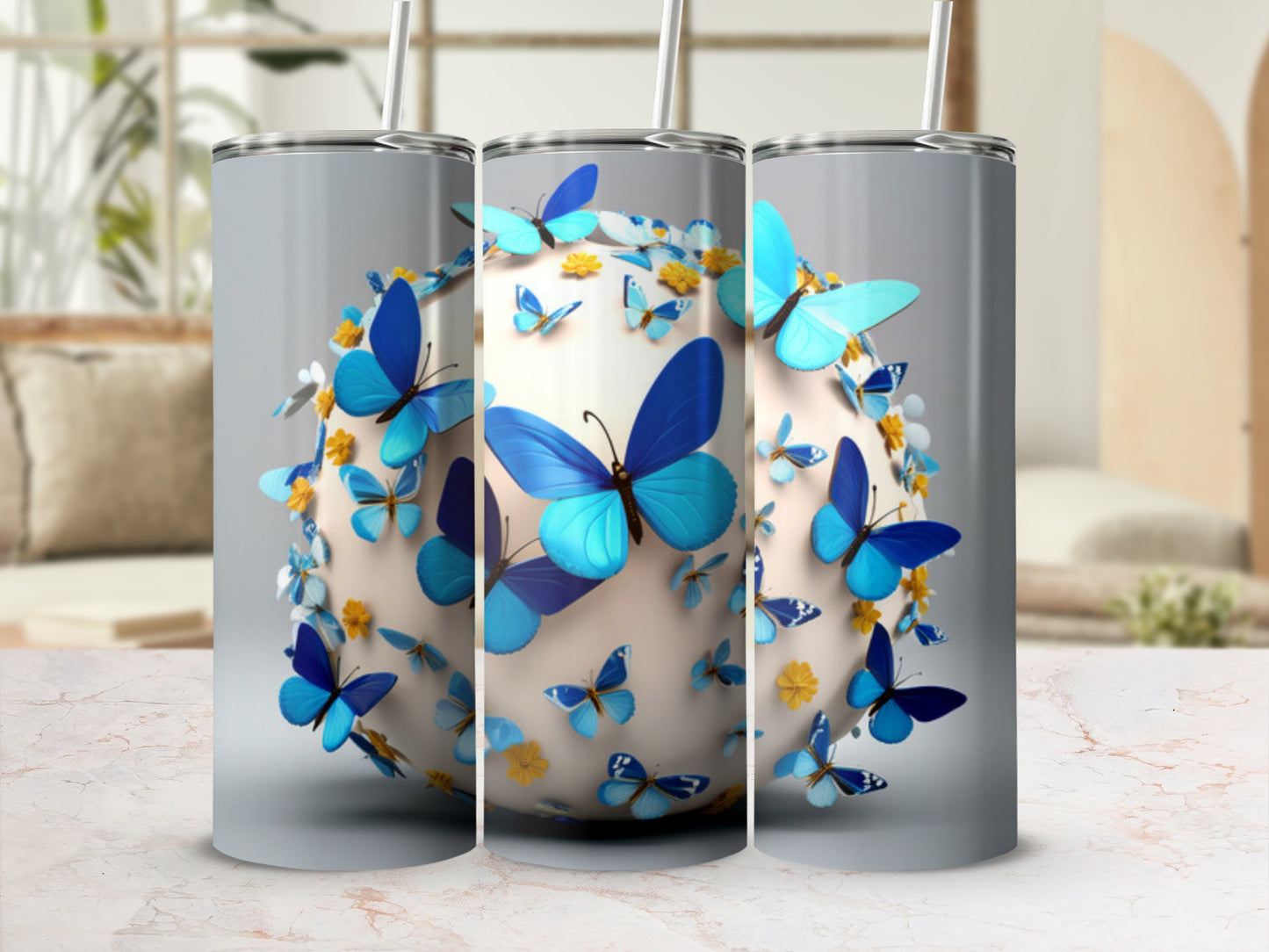 Three tumblers decorated with blue butterflies and yellow flowers.