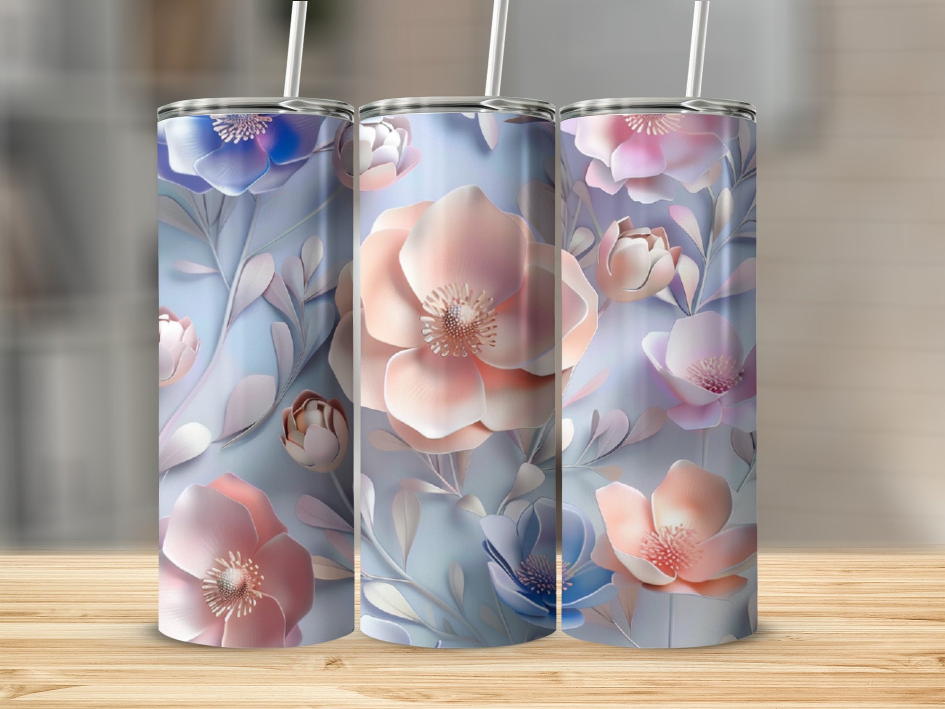 Three tumblers with a floral pattern of pink and blue flowers and leaves.