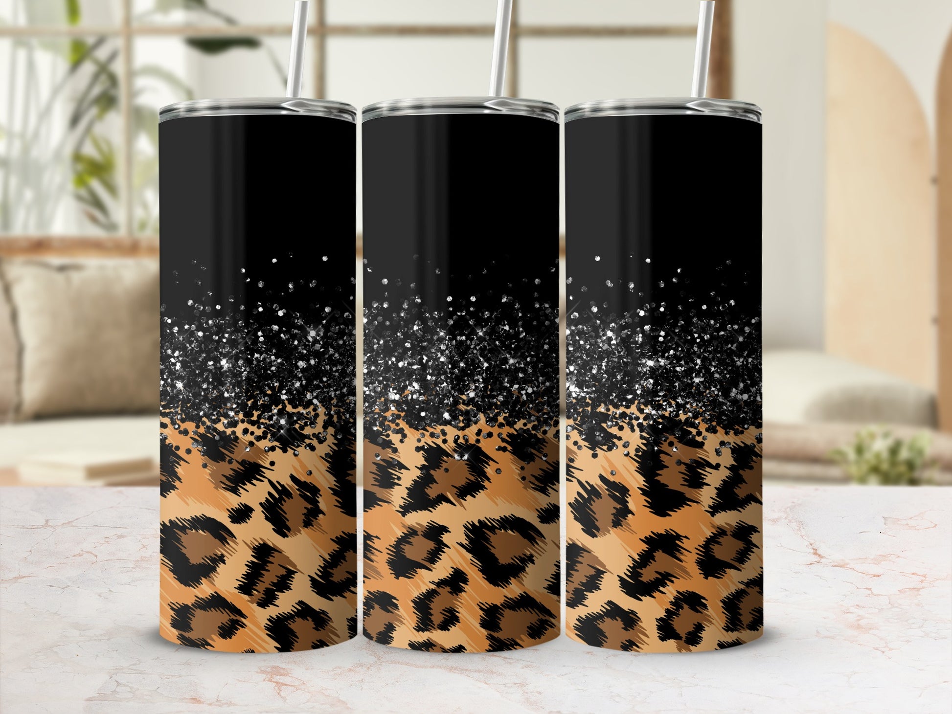 Three tall tumblers with leopard print and glitter.