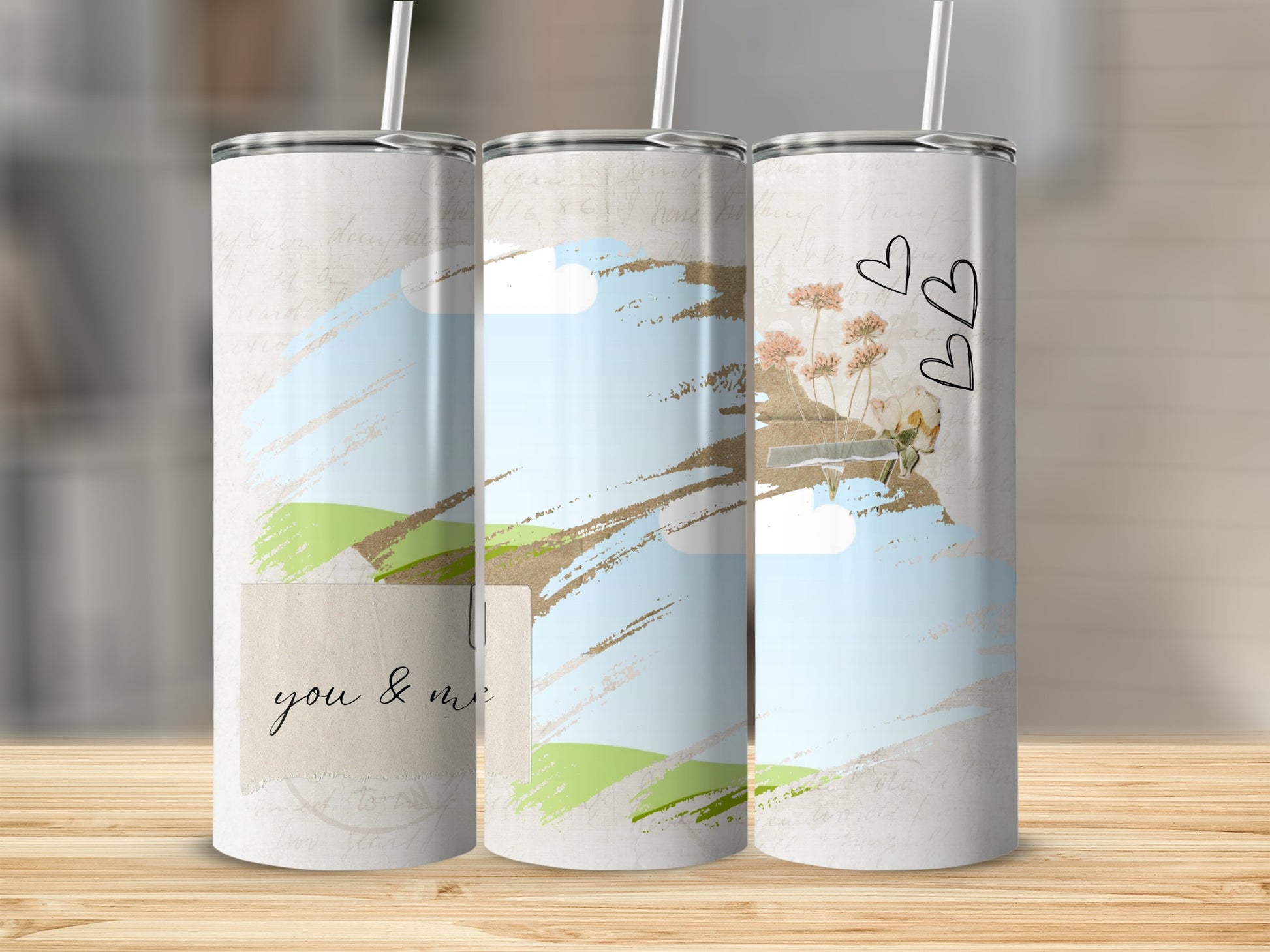 Three tumblers with a pastel, sketched landscape and floral design.