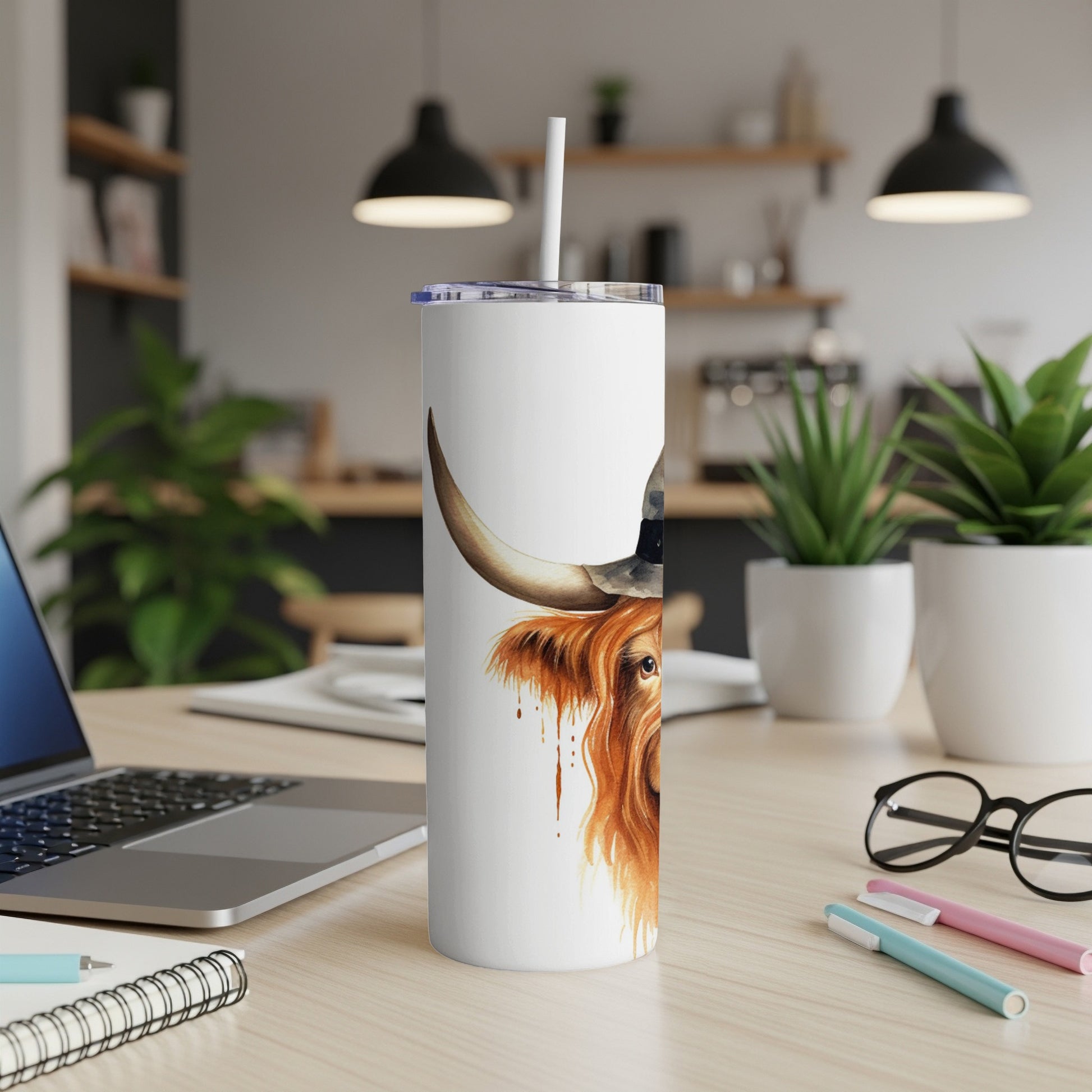 White tumbler with Highland cow wearing a hat and straw.