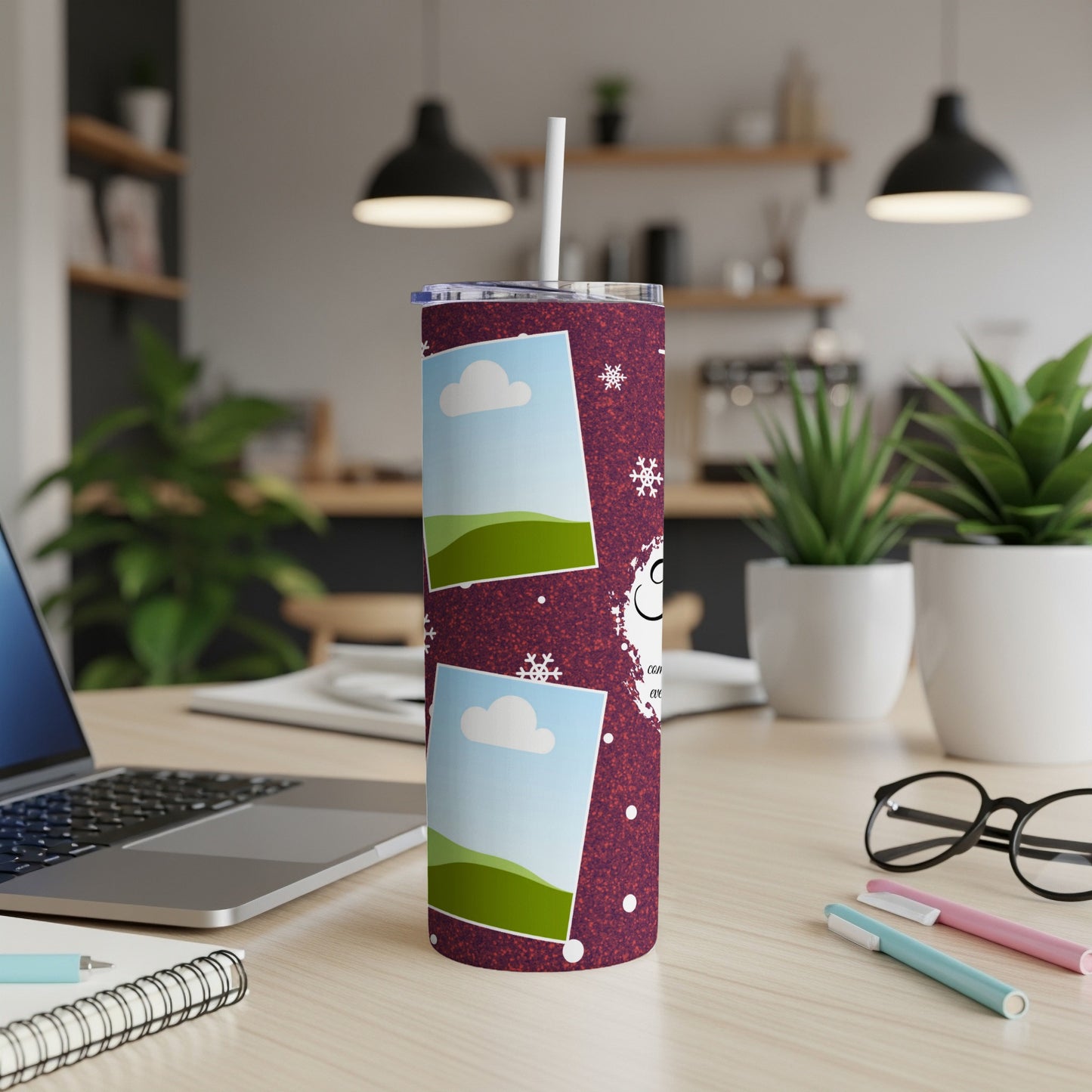 Tumbler with snowflakes and photo frames on a speckled maroon background.