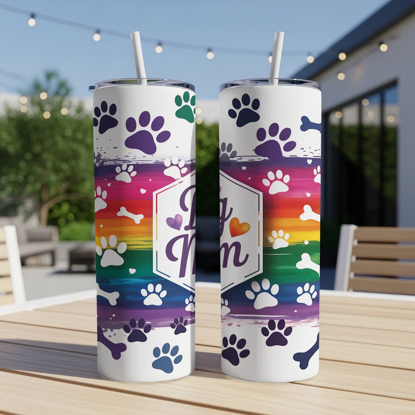 White tumbler with "Dog Mom" text and rainbow paw print design.