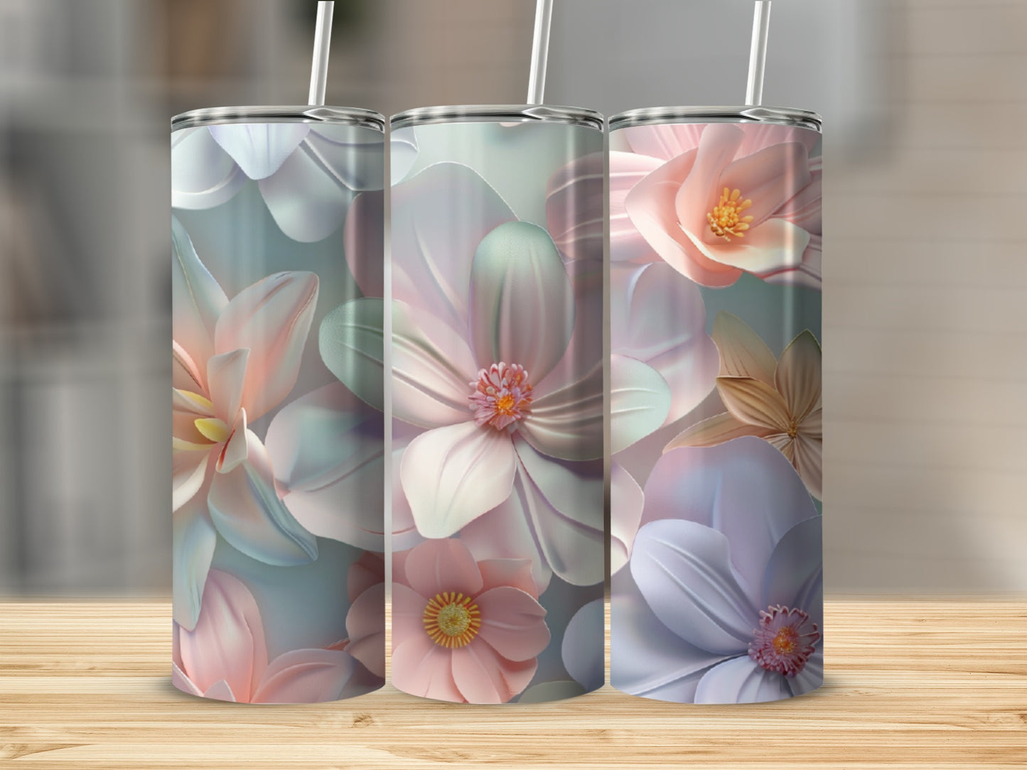 Three tall tumblers with a pastel floral design on a wooden surface.