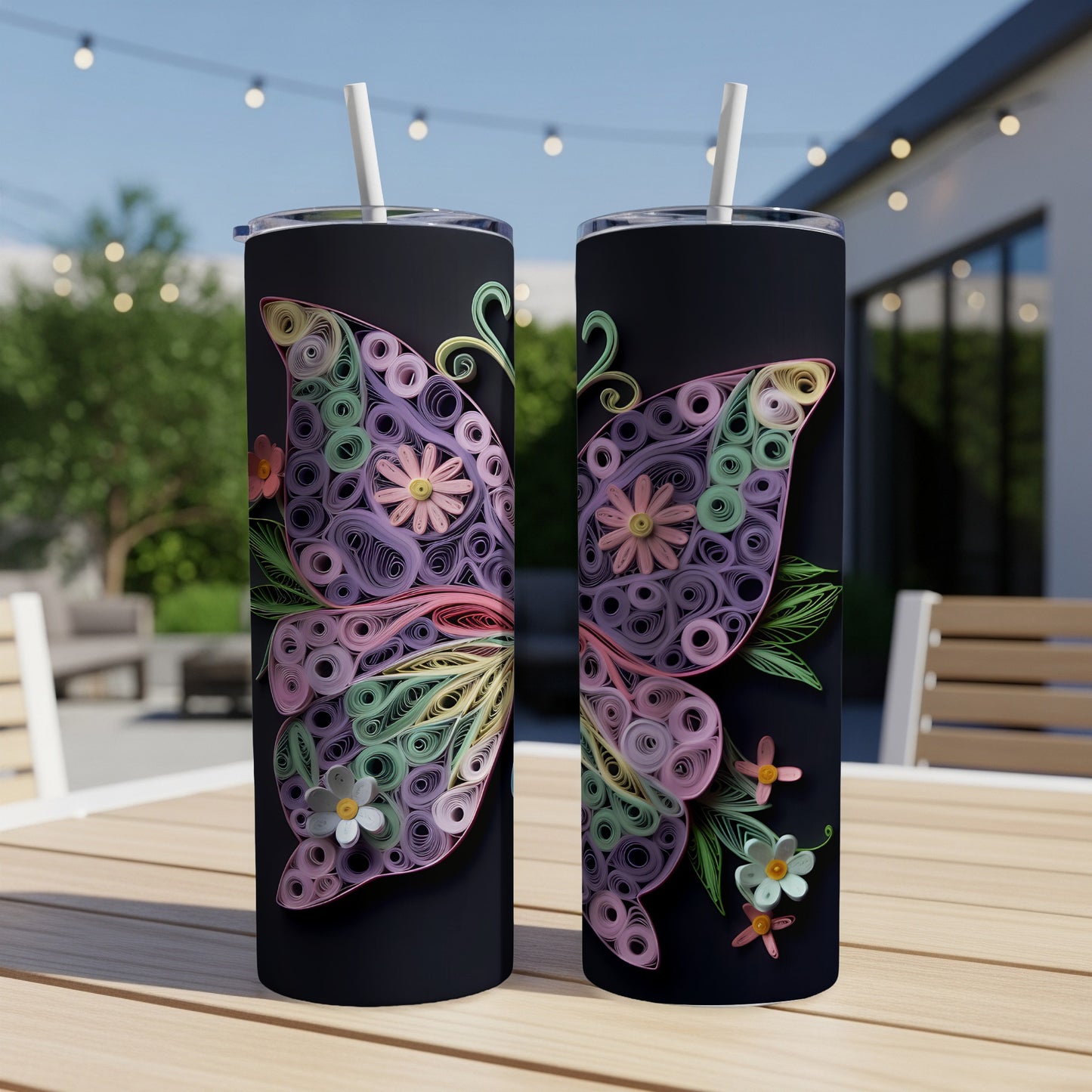 Two black tumblers with colorful quilled butterfly and floral designs.