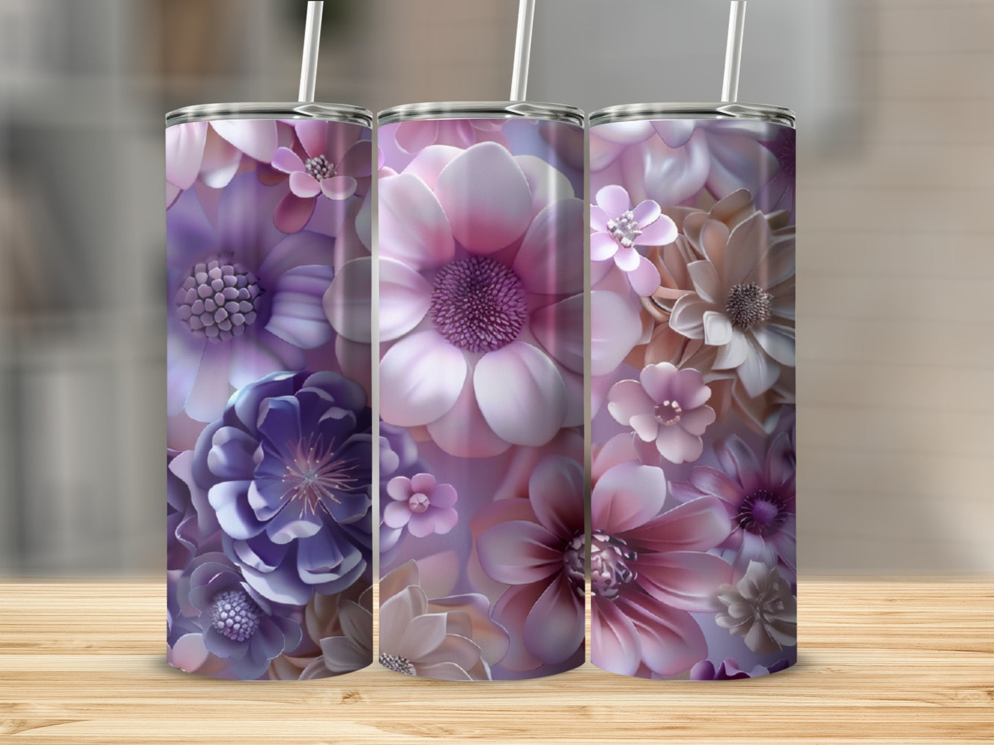 Three tumblers with purple and pink floral designs arranged on a wooden surface.