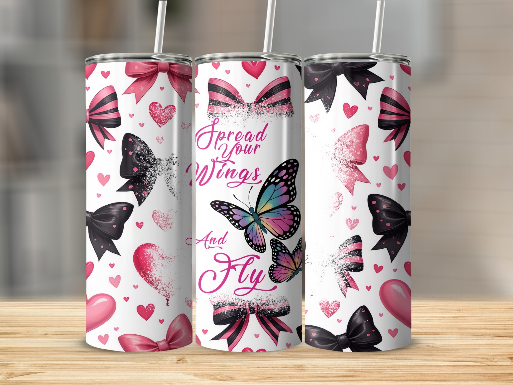 Pink and black bow, heart, and butterfly tumbler with "Spread Your Wings and Fly" text.