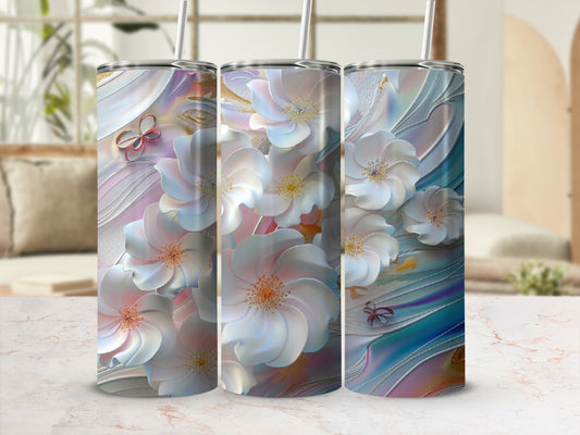 Three tumblers with iridescent floral and butterfly designs on a marble surface.