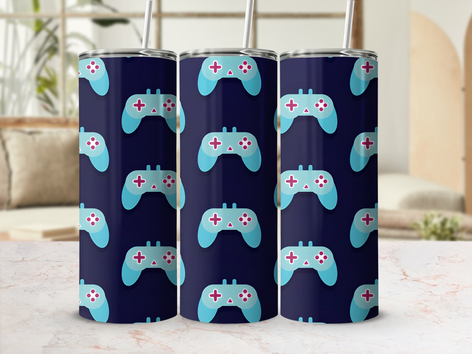 Tumbler with repeating pattern of blue and pink video game controllers on a dark blue background.