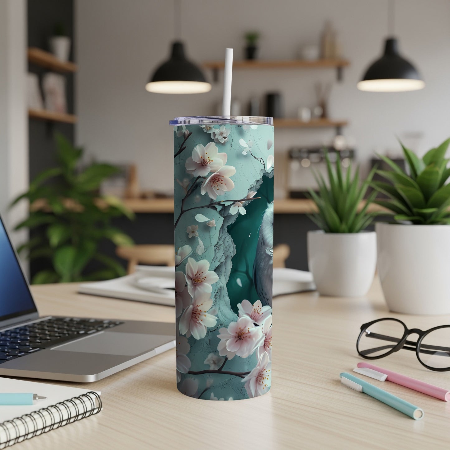 Blue tumbler with a floral cherry blossom and bird design.