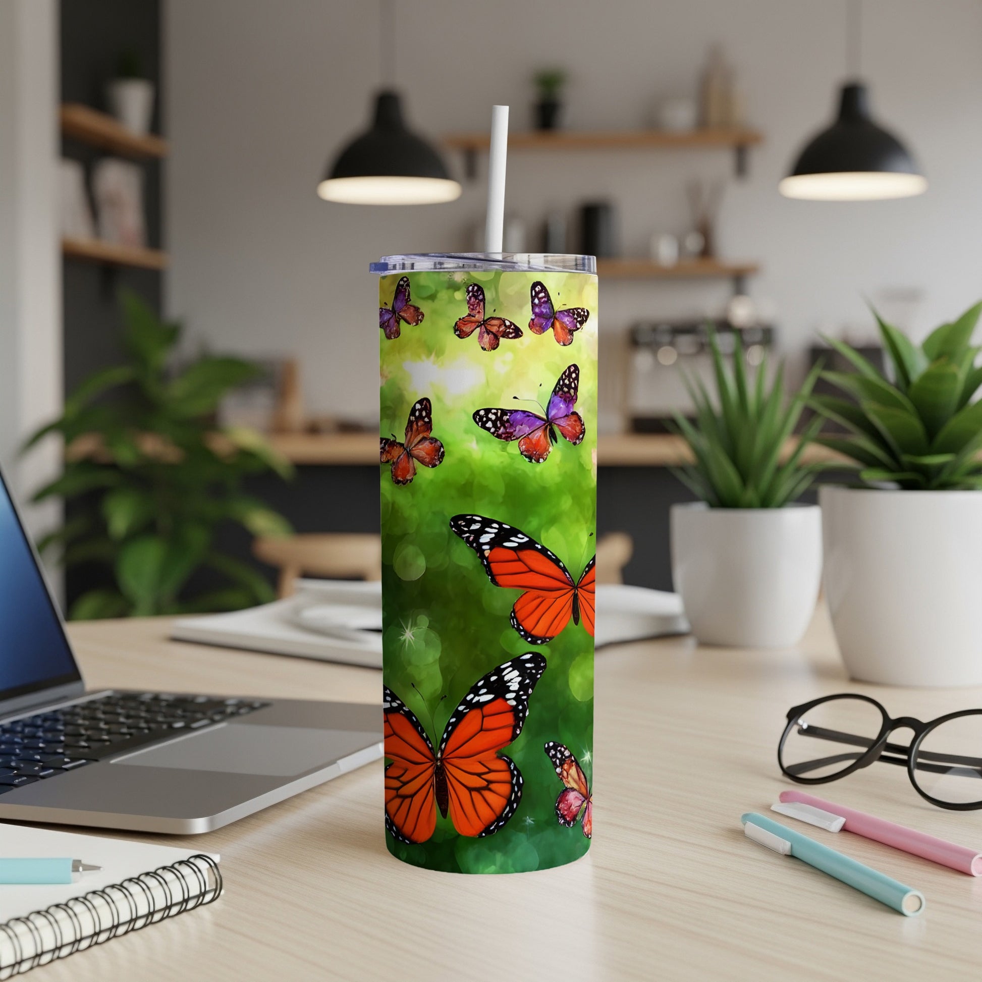 Tall tumbler with monarch butterflies and green watercolor background.