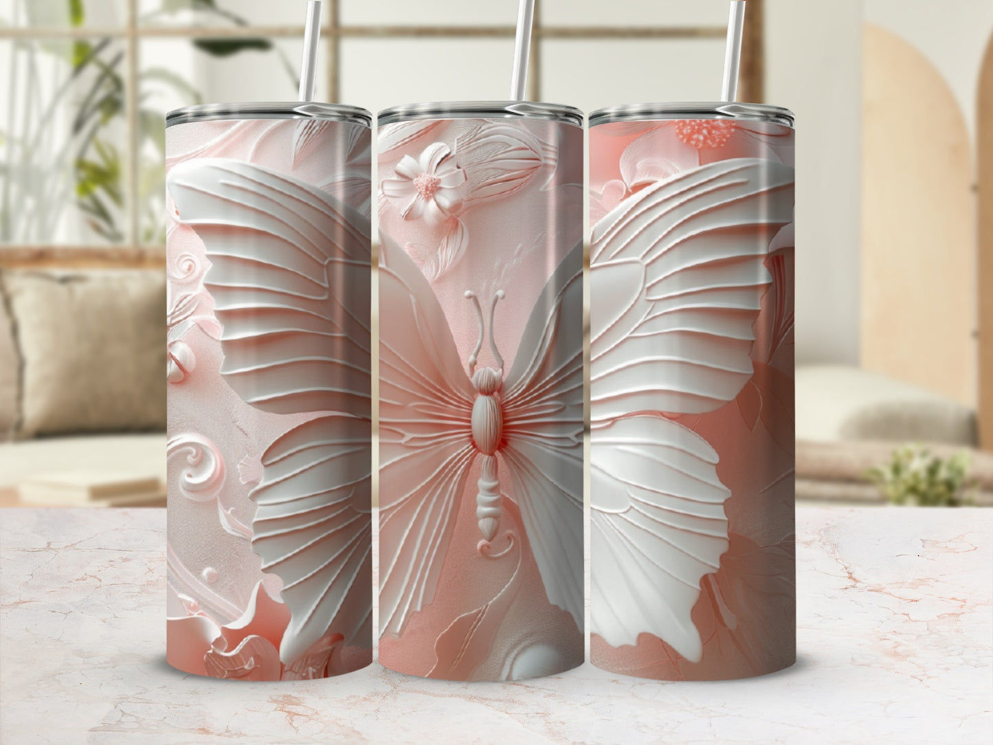 Three pink tumblers with detailed butterfly and floral embossed designs.