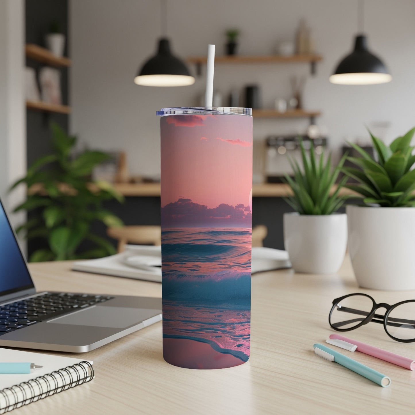 Pink and blue ocean waves at sunset on a white travel tumbler.