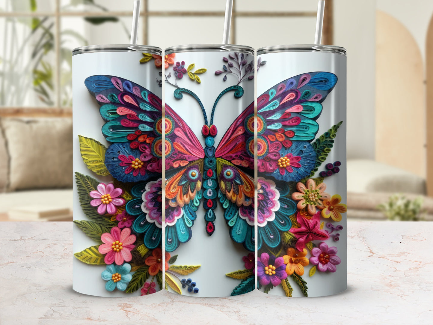 Three stainless steel tumblers with vibrant, colorful butterfly and floral designs.