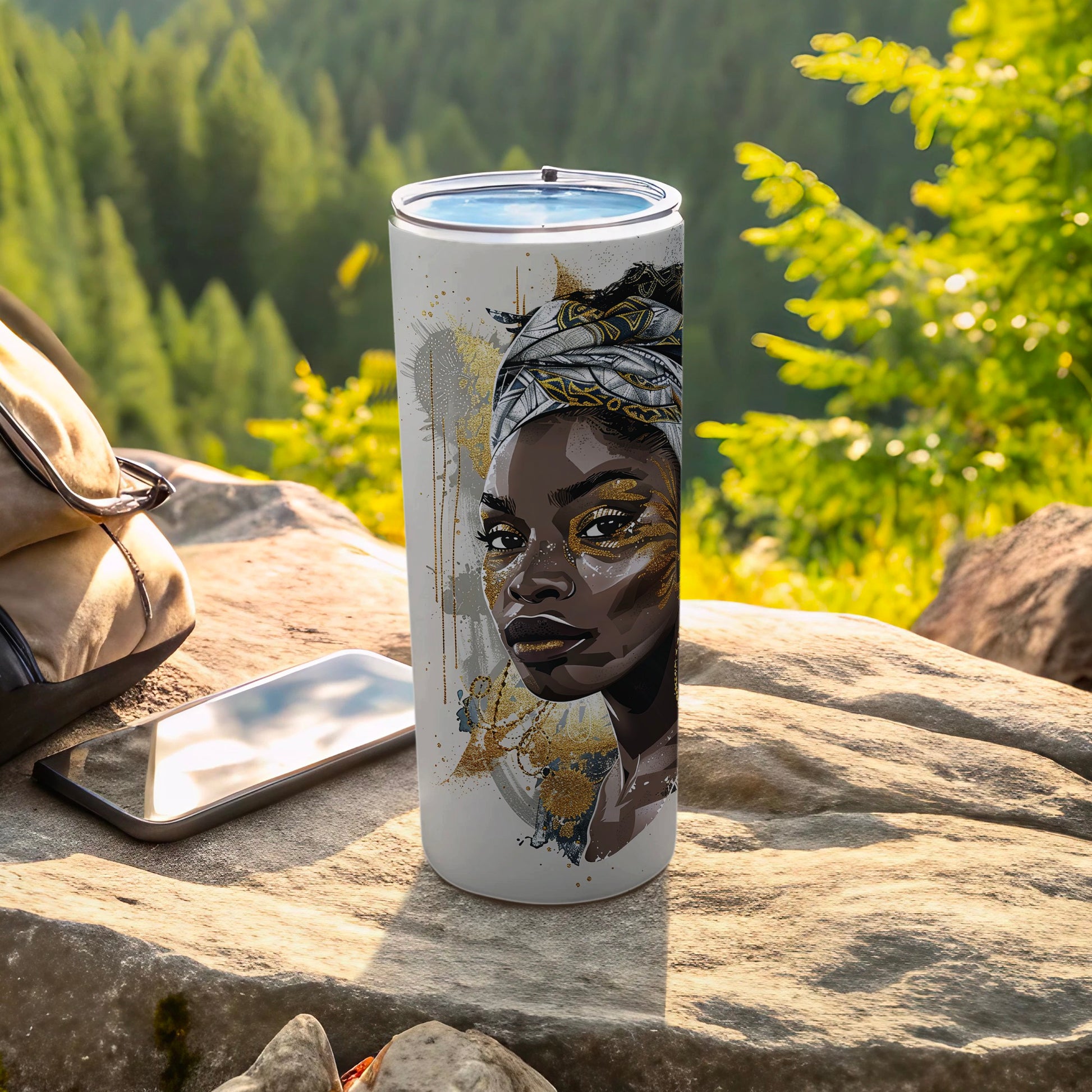 White tumbler featuring a portrait of a woman with gold accents and tribal headdress.