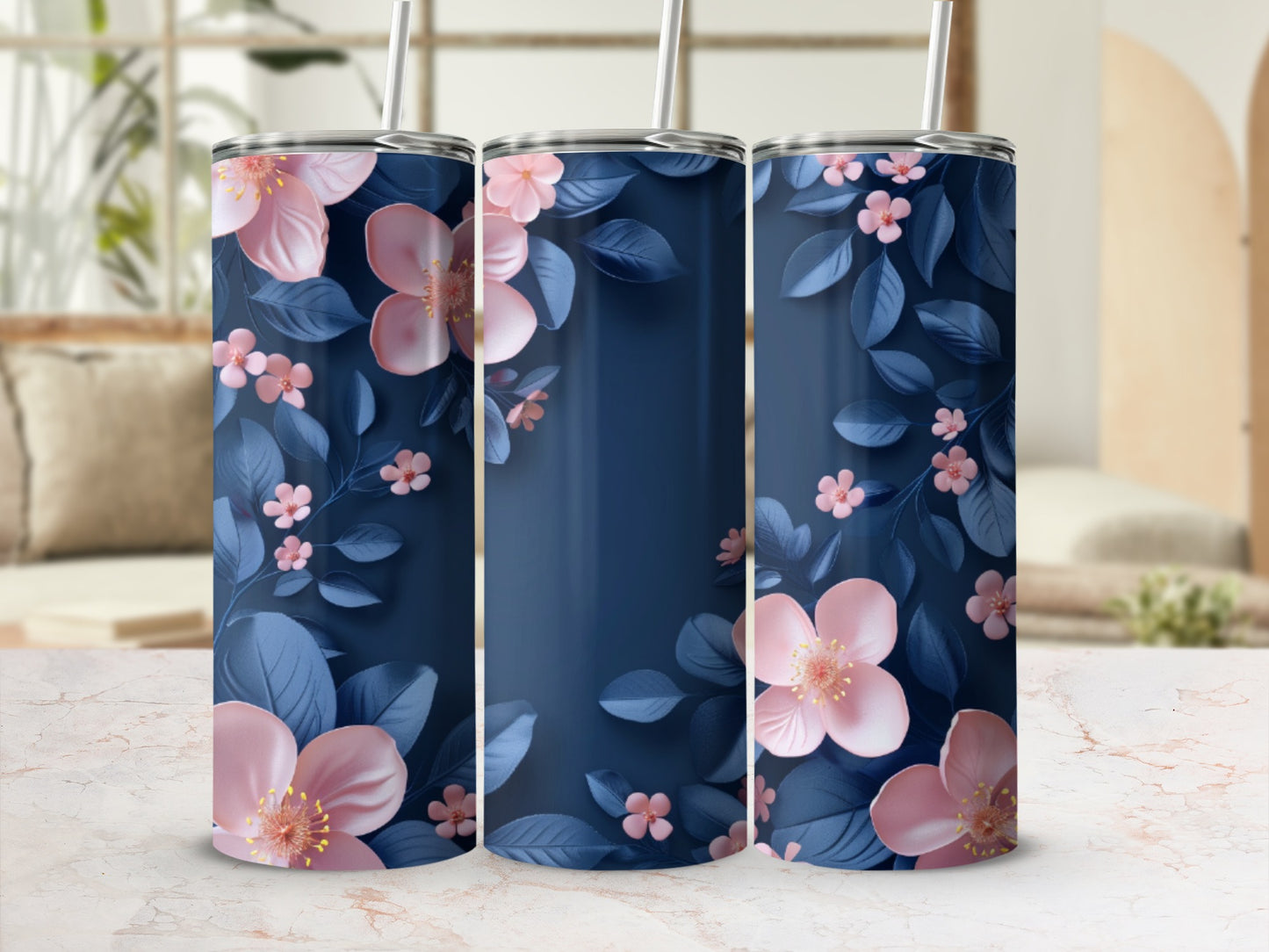 Three navy blue tumblers with pink flowers and blue leaves.
