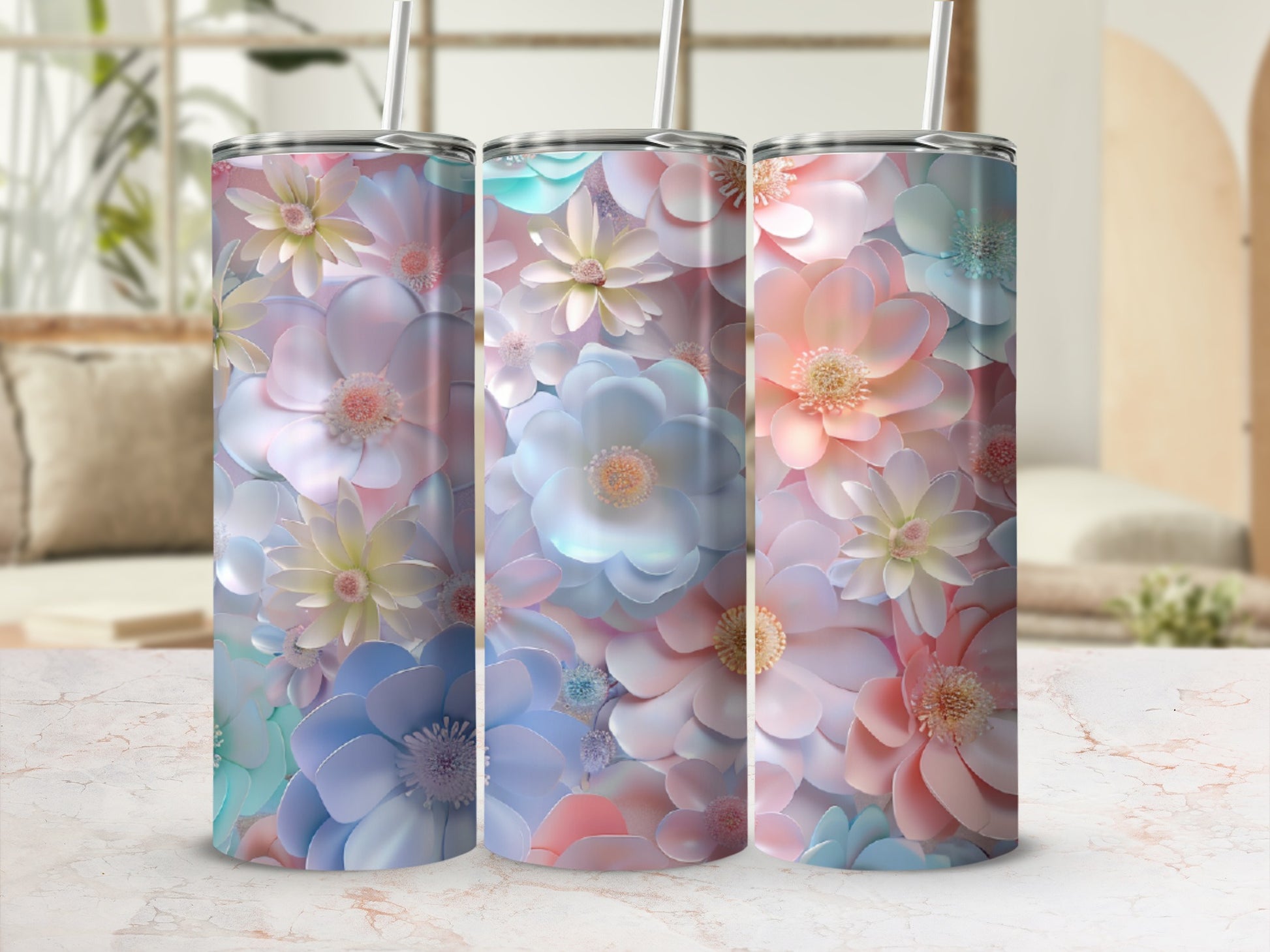 Three tumblers with pastel floral designs displayed in soft lighting.