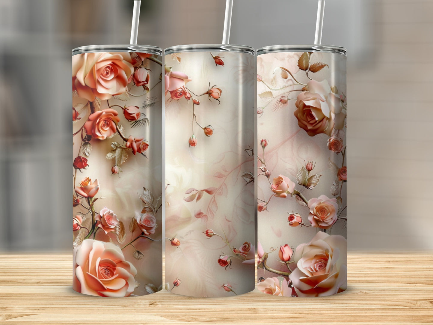 Three tumblers with a romantic floral rose pattern on a wooden surface.