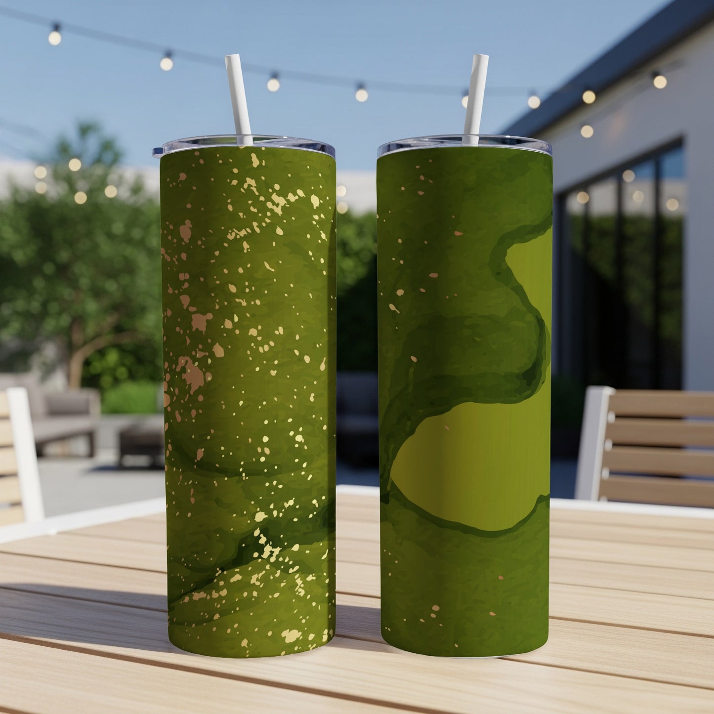 Two green tumblers with gold speckles on a table.