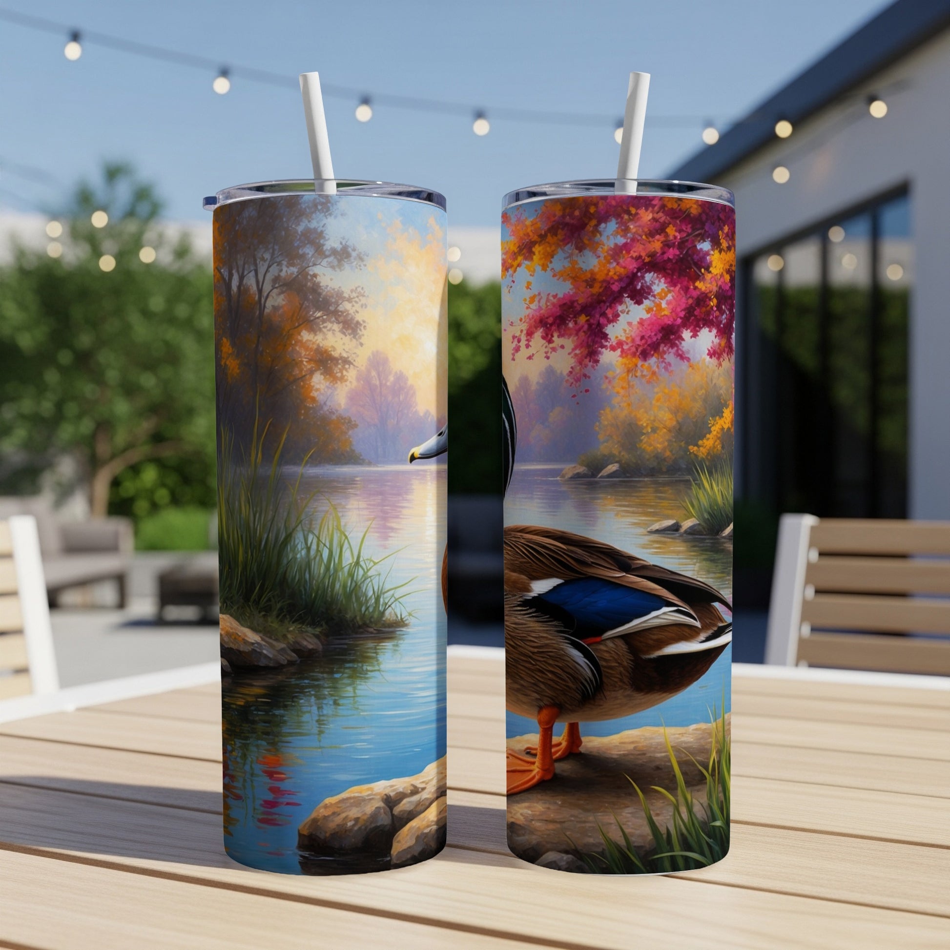 Two tall tumblers with a realistic duck by a lake design.