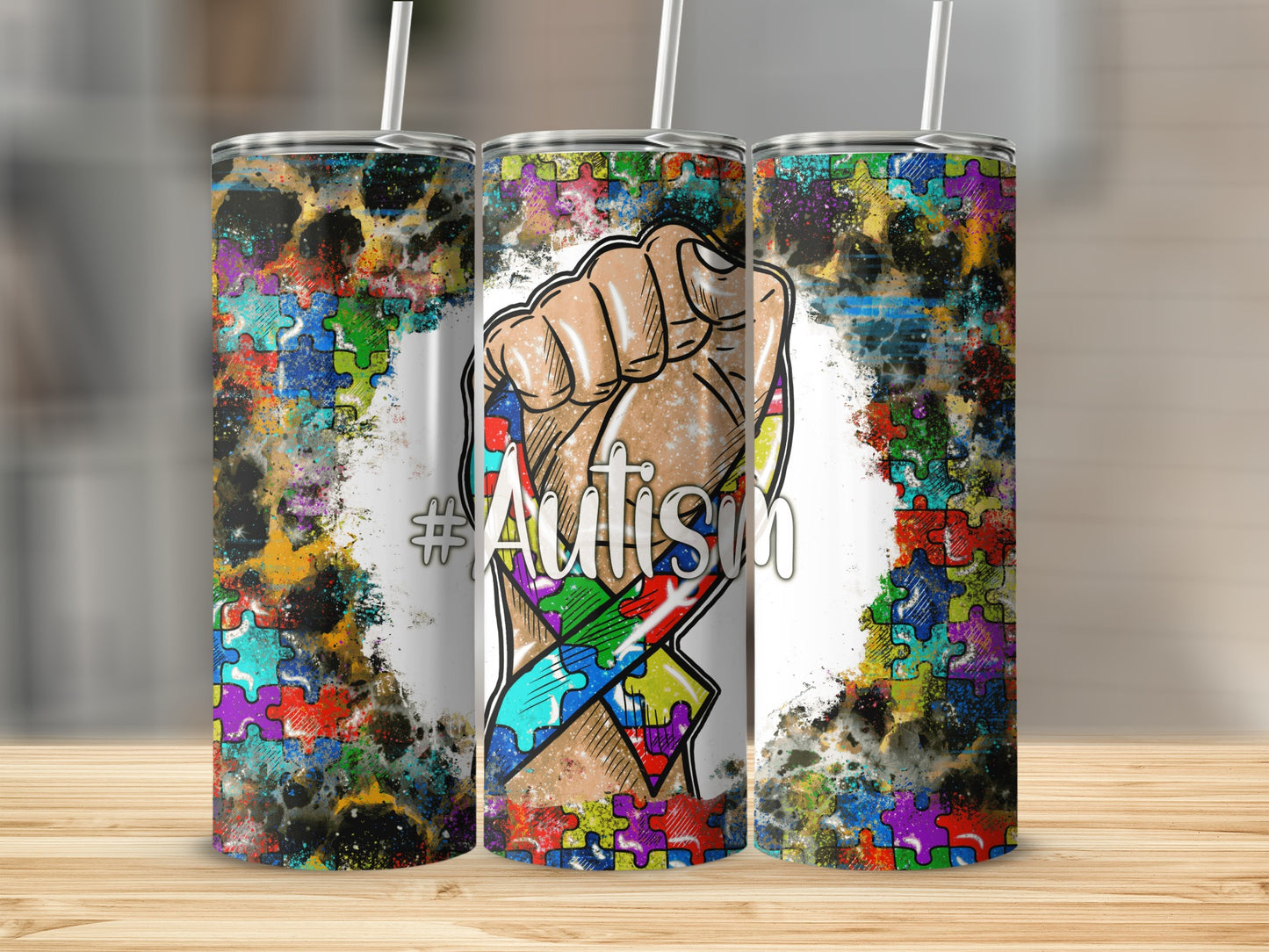 Tumbler with autism puzzle ribbon and clenched fist graphic.