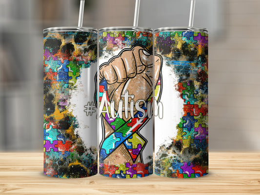 Tumbler with autism puzzle ribbon and clenched fist graphic.