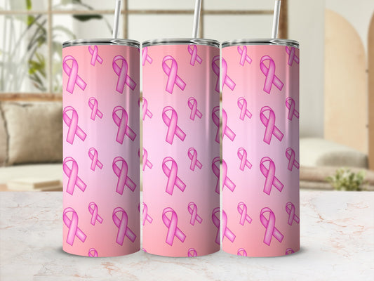 Three pink ribbon tumblers with straw on a marble surface.