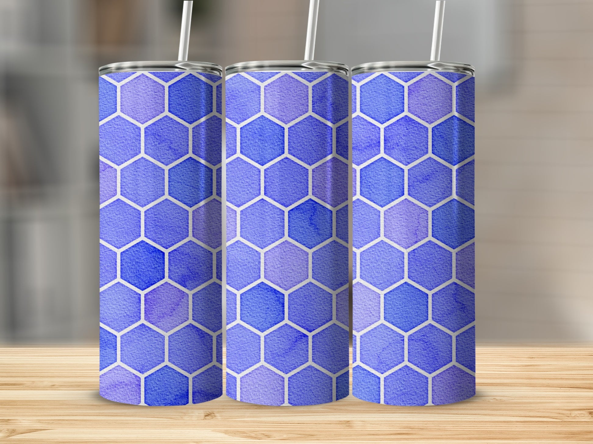 Three tumblers with a blue and purple watercolor hexagon pattern.