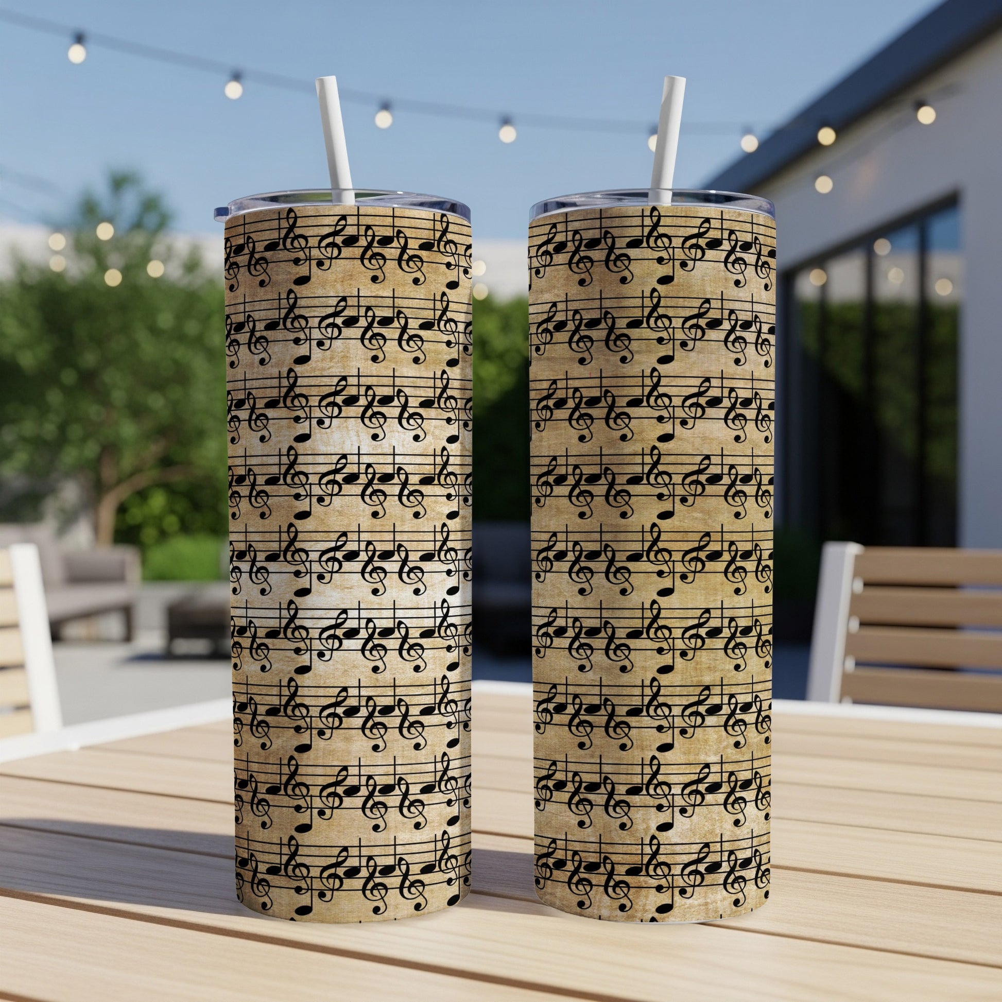 Two tumblers with a vintage music sheet and treble clef pattern.
