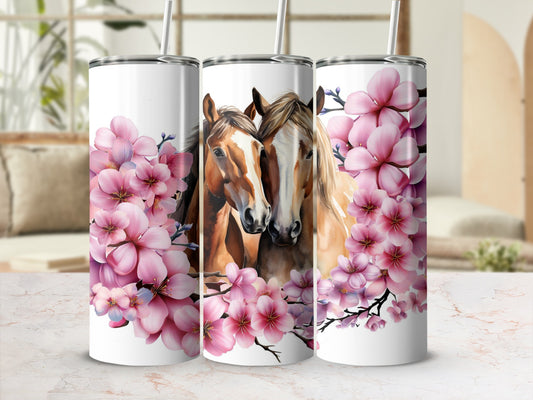 Two horses surrounded by pink cherry blossoms on a white tumbler.
