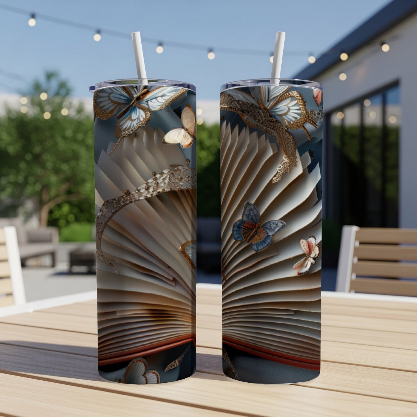 Open book with ornate pages and butterflies, two tumblers on a table.