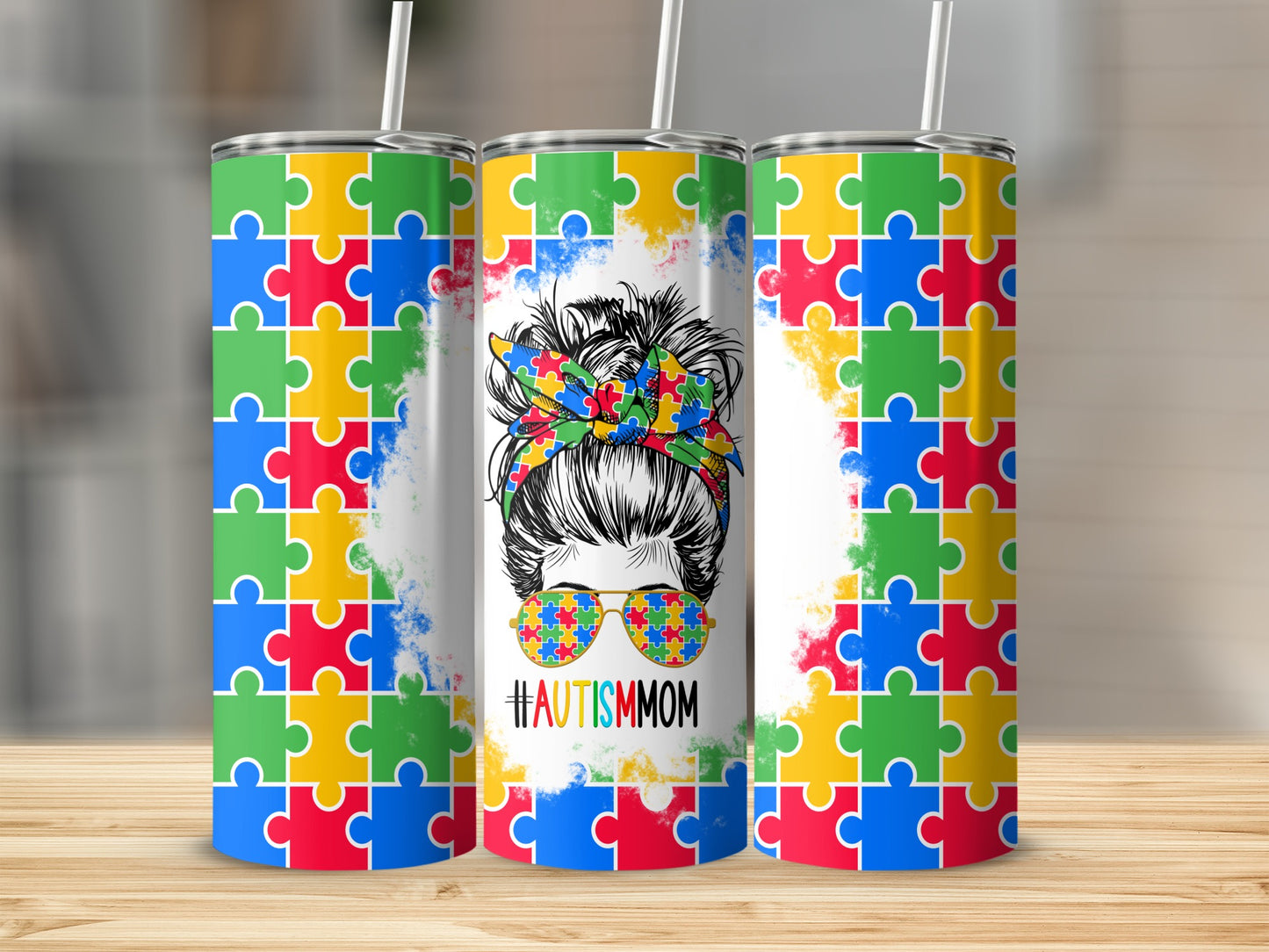 Tumbler with Autism awareness puzzle pattern and messy bun mom graphic.