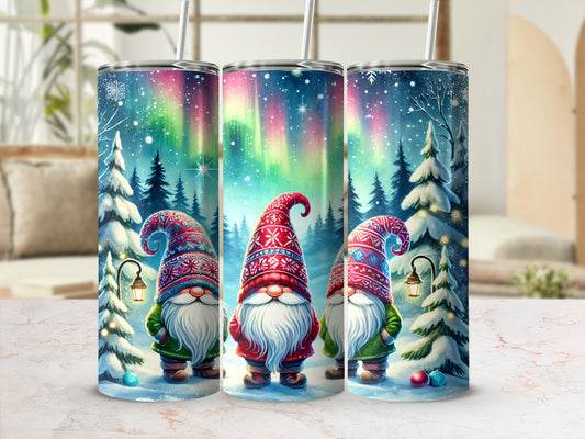 Three Christmas gnomes in a snowy forest under the Northern Lights.