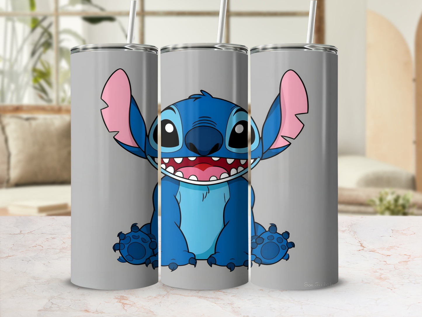 Blue Stitch character on three gray tumblers with straws.