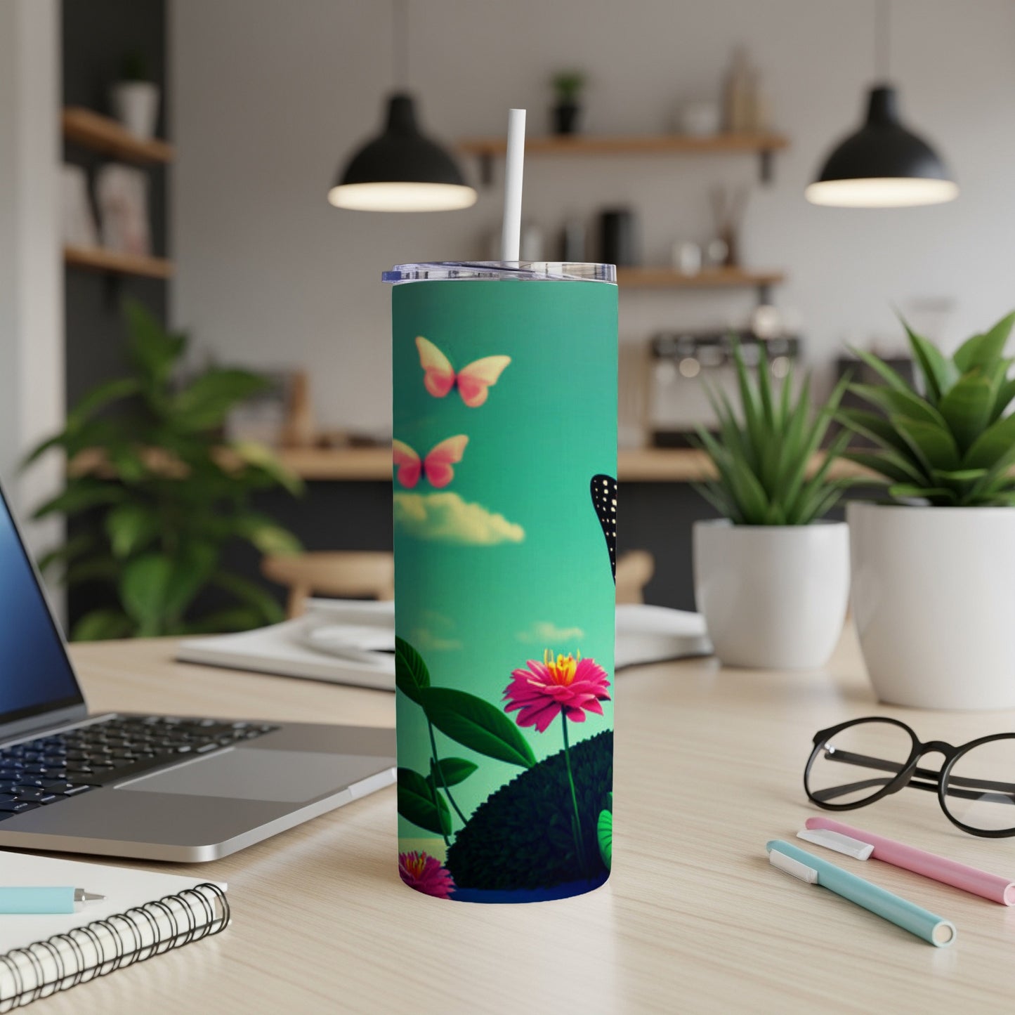 Tall tumbler with butterflies and pink flower on teal background.