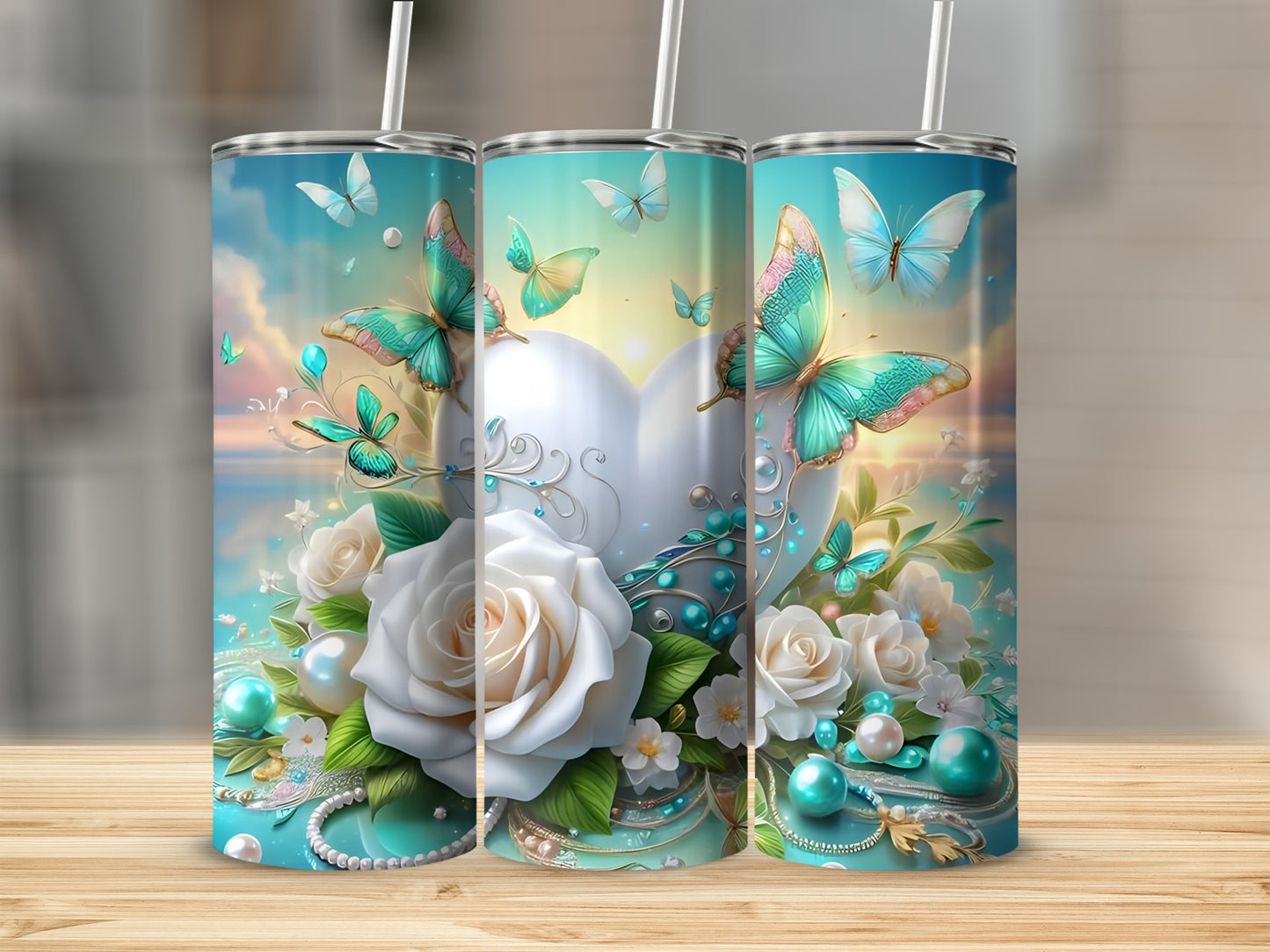 Three tumblers with a white heart, roses, and teal butterflies.