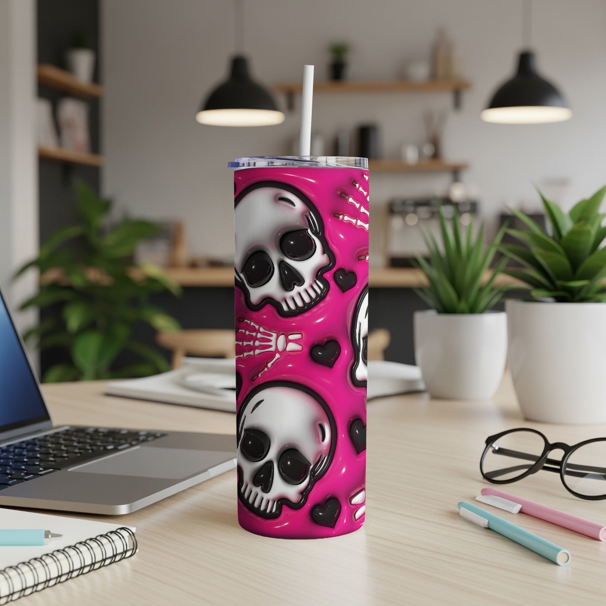 Pink tumbler with white skulls and skeleton hands pattern.