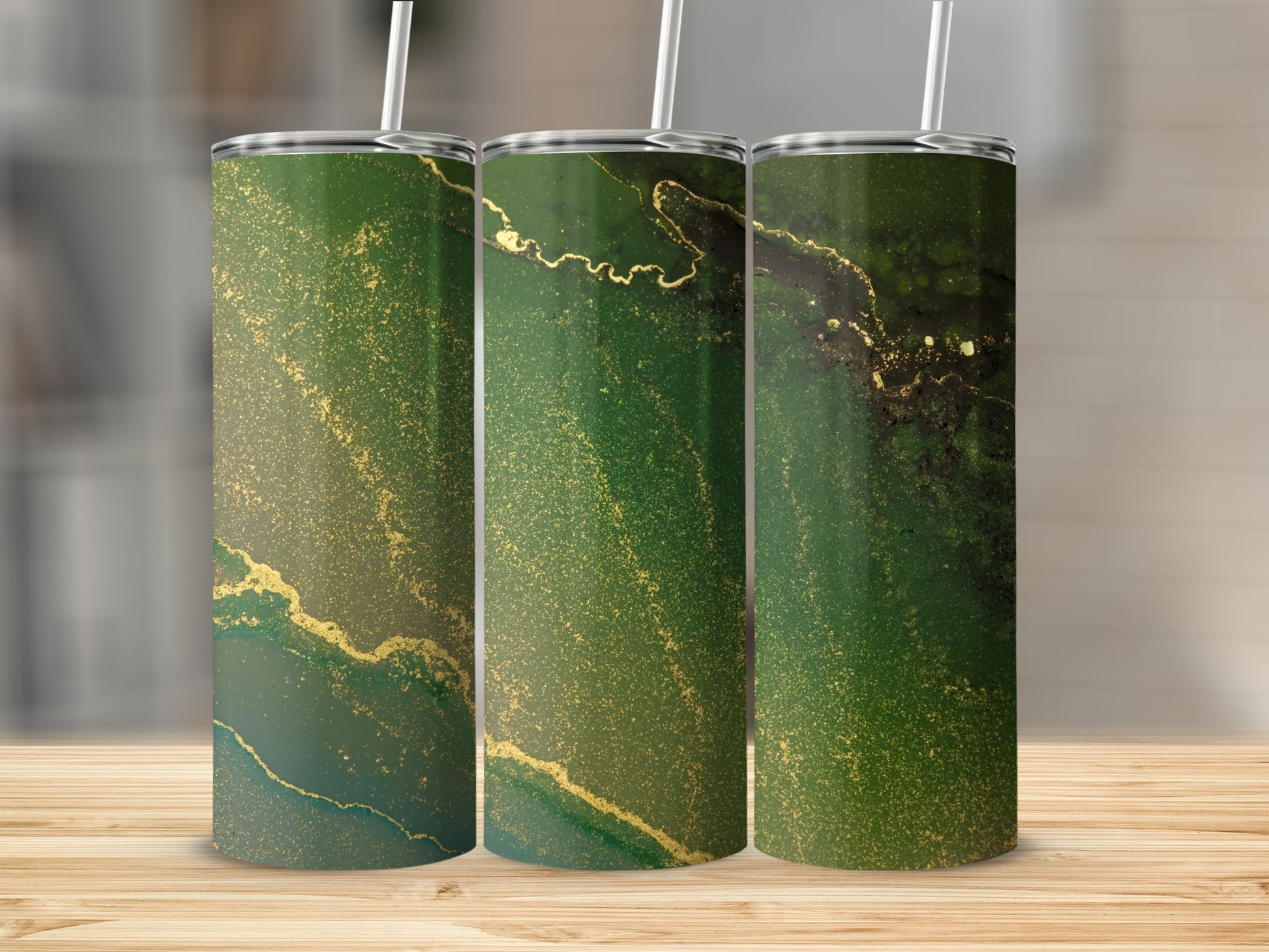 Three green tumblers with abstract gold marbling patterns.