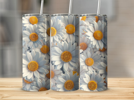 Three tumblers with a repeating daisy floral pattern on a wooden surface.