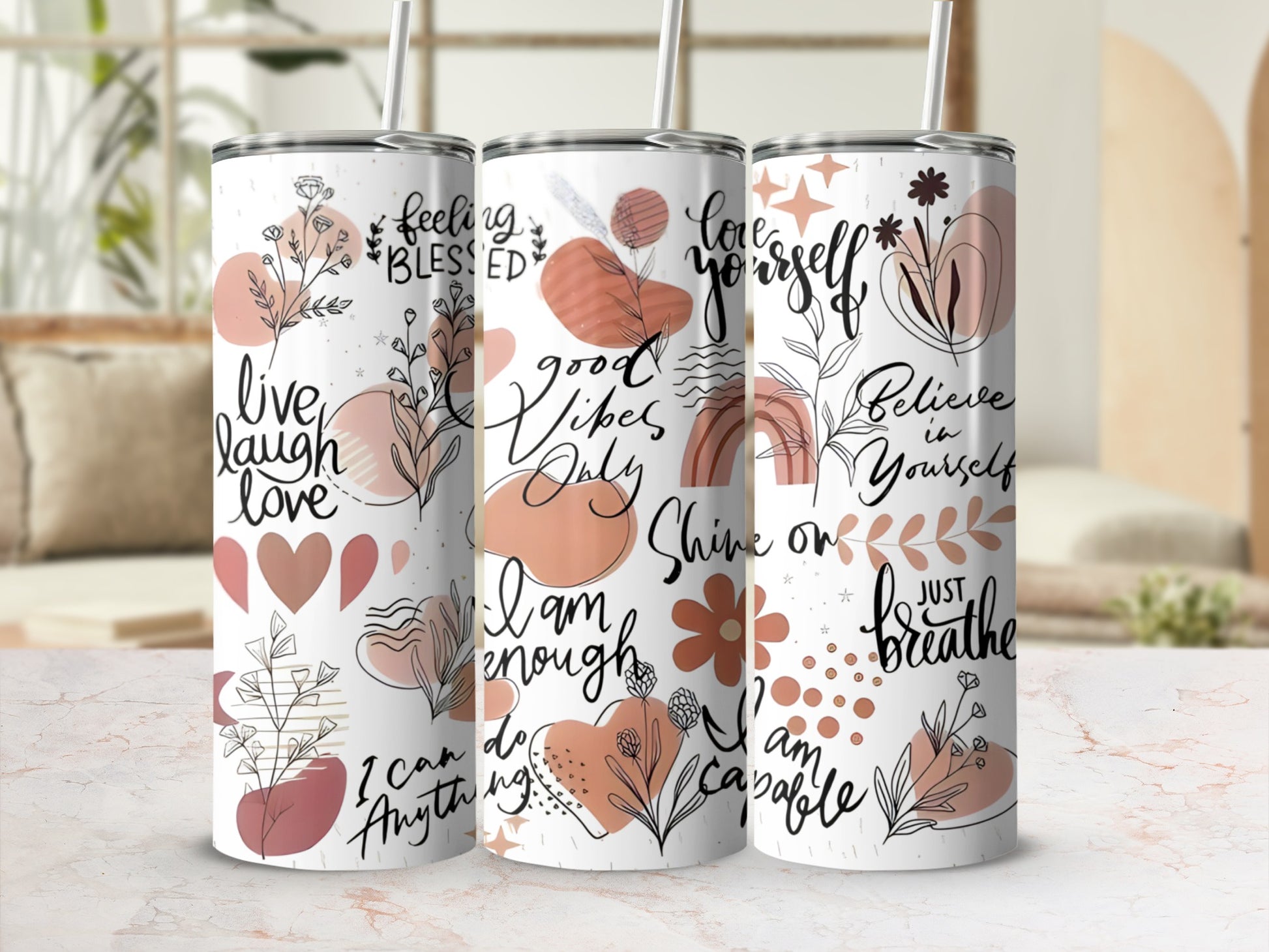 Three tumblers with floral and inspirational text designs: "live laugh love", "good vibes only", and "Believe in yourself".