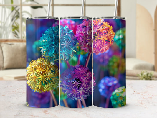 Three tumblers with colorful dandelion-like floral designs, displayed on a marble surface.