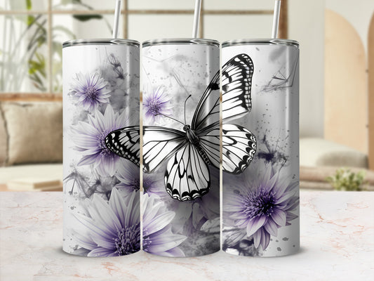 White butterfly on purple floral tumbler with straw.