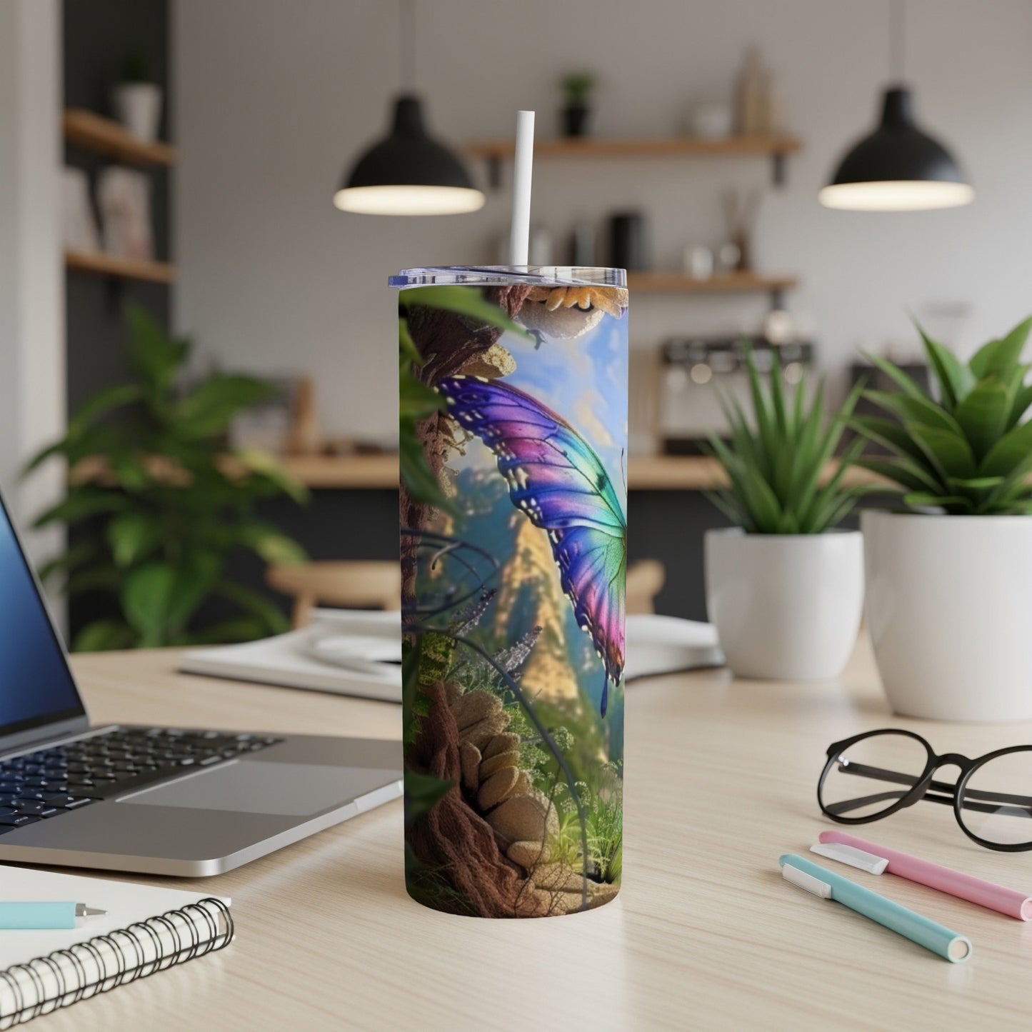 Colorful butterfly on a nature-themed tumbler with a straw on a desk.